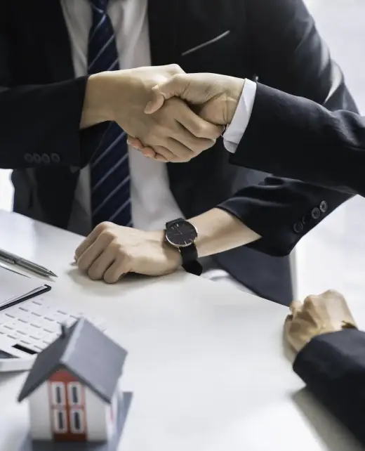 Successful deal Real estate lease or home purchase concept buyer shakes hands with bank employee after office contract is completed.